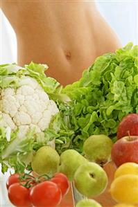 Fruit & vegetables in front of someone's bare midriff