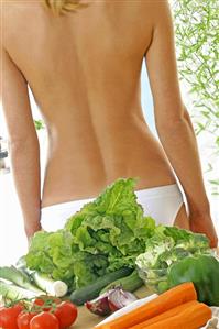 Fruit and vegetables in front of someone's bare back