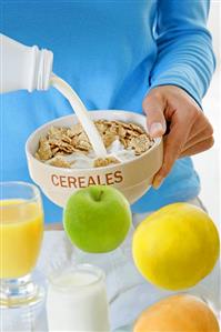 Pouring milk onto cornflakes