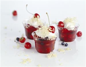 Red fruit compote with cream and elderflowers