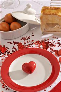 Place-setting with hearts, boiled eggs and toast