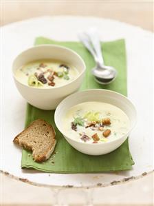 Potato soup with ramsons (wild garlic), prunes and bacon