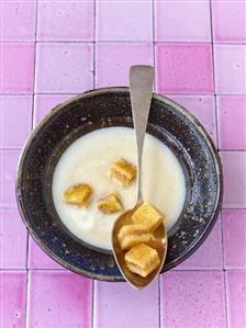 Cream of celery soup with salmon croutons