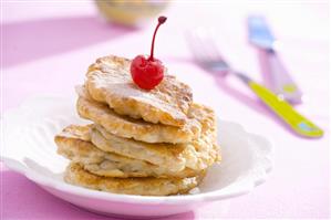 Apple pancakes with a cocktail cherry