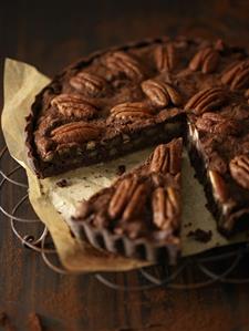 Chocolate pecan tart, a piece cut