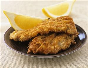 Wiener schnitzel (breaded veal escalopes) with lemon wedges