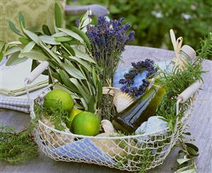 Basket of herbs, olive oil, limes & shells to give as a gift