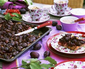 Plum cake, coffee cups in background