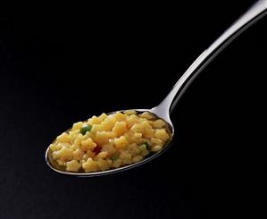 Soup with pasta stars on spoon