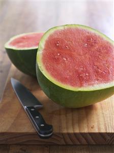 Halved watermelon with knife