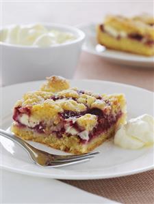 A piece of raspberry cake with white chocolate, cream