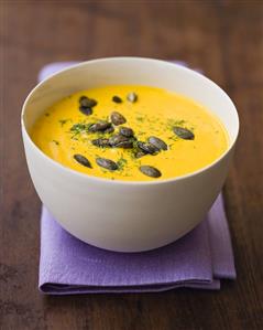 Cream of pumpkin soup with pumpkin seeds and dill