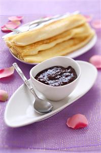 Plum jam with cocoa powder and pancakes