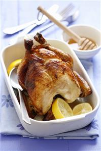 Whole roast chicken with lemon slices