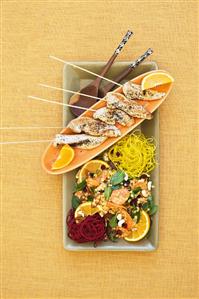 Chicken skewers with lentil salad and orange slices