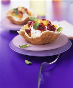 Waffle bowl filled with ice cream and fruit sauce