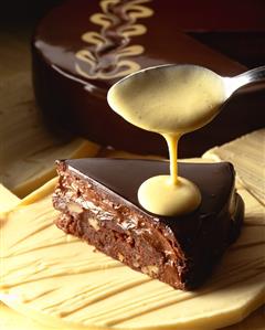 A piece of chocolate cake with custard