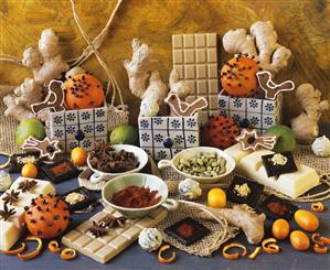 Still life with chocolate, spices and studded oranges