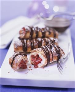 Puff pastries with raspberry filling and chocolate drizzle