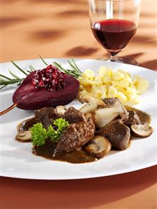 Venison ragout with mushrooms, red wine pear, cranberries, spaetzle