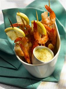 Prawn skewers with lemon slices and dip