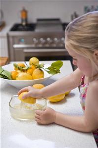 Girl squeezing a lemon