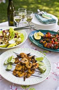 Grilled prawn kebabs, lamb kebabs & salad leaves with pear