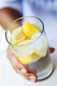 Hand holding a glass of lemonade