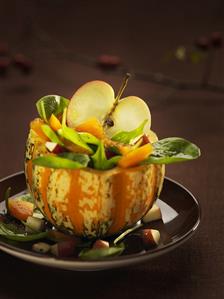 Pumpkin and apple salad in half a pumpkin