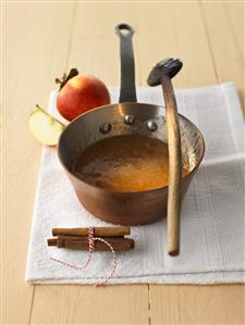 Apple and cinnamon jam in a copper pan