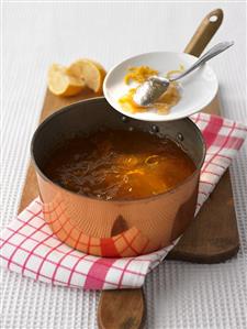 Mirabelle and apple jam in copper pan and on plate