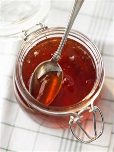 Quince jelly in jar with spoon