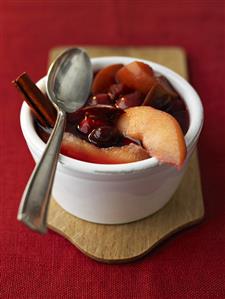 Bottle fruit with rum and cinnamon stick