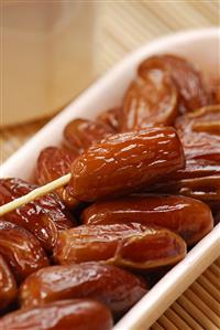 Dried dates with plastic fork (close-up)