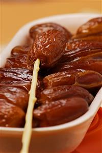 Dried dates with plastic fork (close-up)