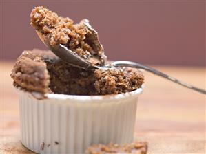 Chocolate soufflé in soufflé dish and on spoon