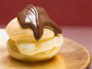 Profiterole with chocolate sauce and vanilla cream