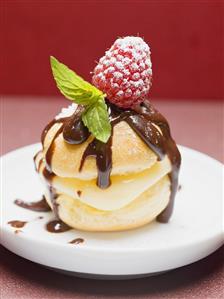 Profiterole with chocolate sauce, cream, raspberry & mint