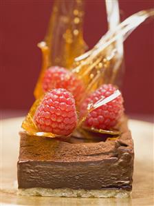 Small chocolate cake with raspberries & caramel shards