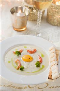 Potato soup with crayfish and quail's egg for Christmas