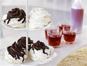 Meringues with chocolate on tiered stand