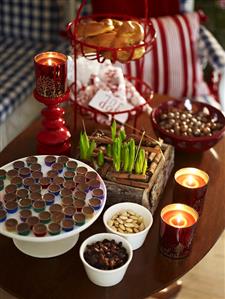 Chocolates, almonds, candles in glasses & container of bulbs