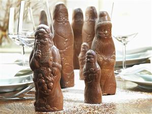 Chocolate Father Christmases with icing sugar on Xmas table