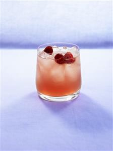 Pomegranate drink with raspberries and ice cubes