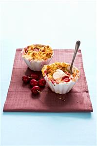 Individual cherry crumbles with cream