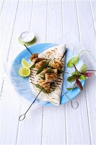 Chicken kebabs on tortilla