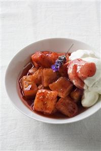 Pineapple with strawberry sauce, lavender & whipped cream