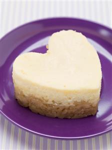 Heart-shaped quark cake on purple plate