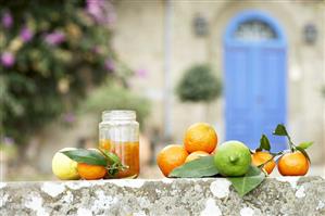 Oranges, lemons, mandarins and jar of orange marmalade