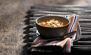 A bowl of lentil soup with cumin, carrot and apple